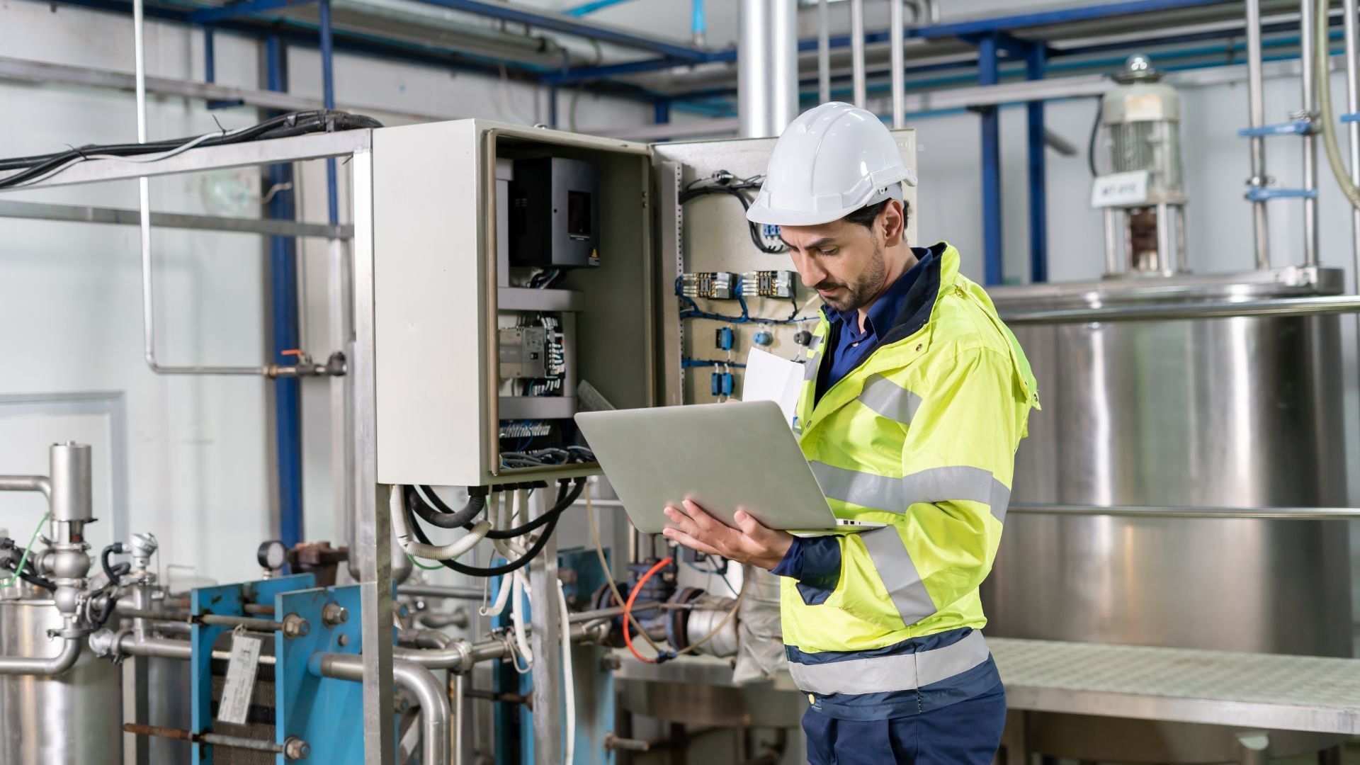 Man in safety gear using laptop